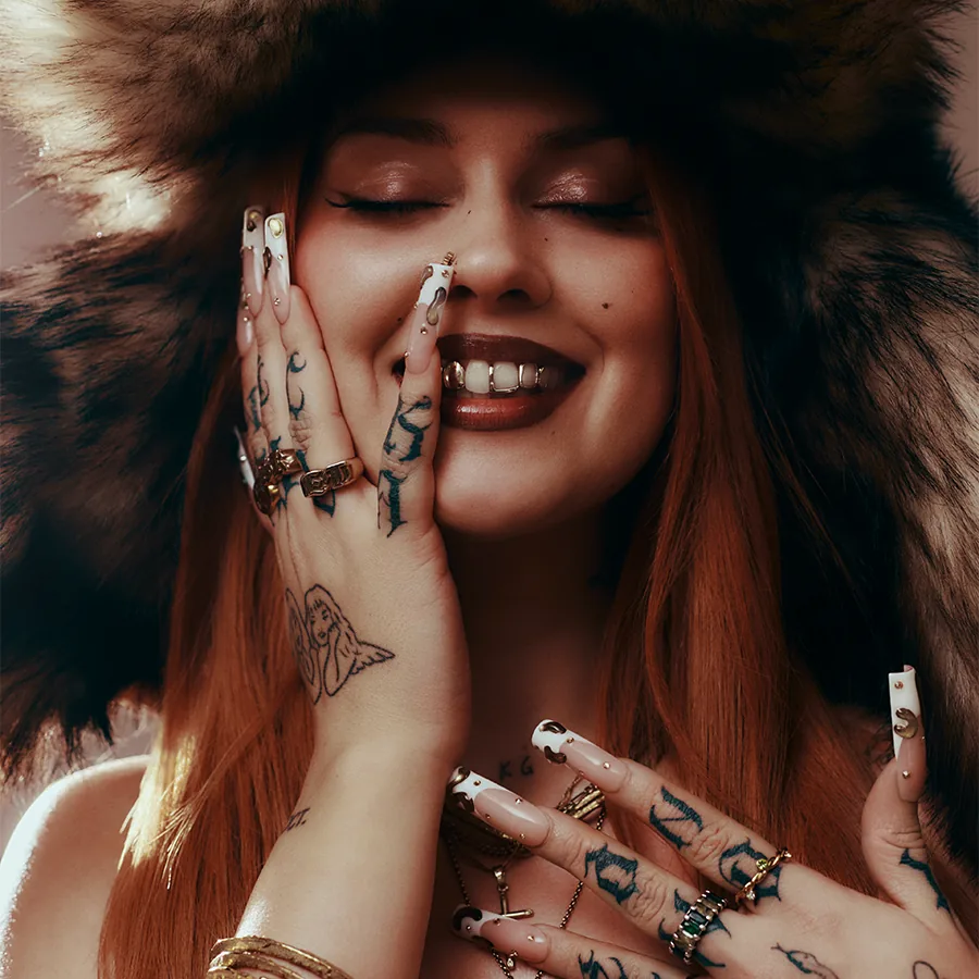 Portrait of Sasha Keable wearing a faux-fur hat