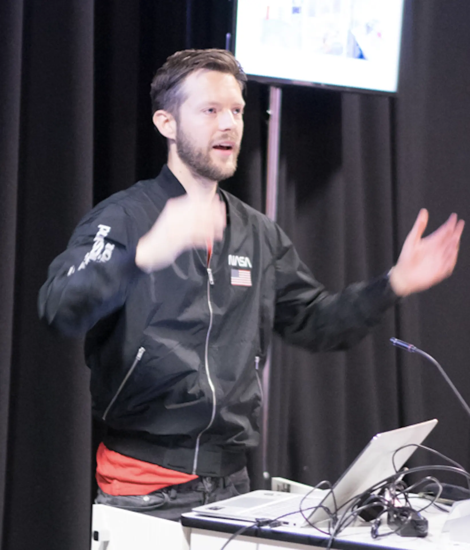 Speaking on stage at a design event