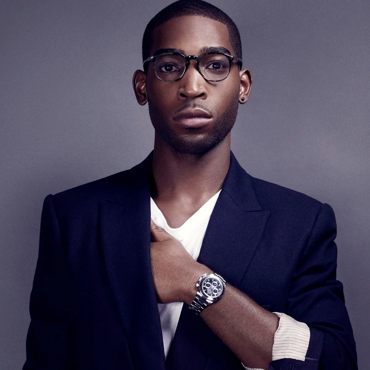 Portrait of Tinie Tempah wearing glasses and a navy blazer